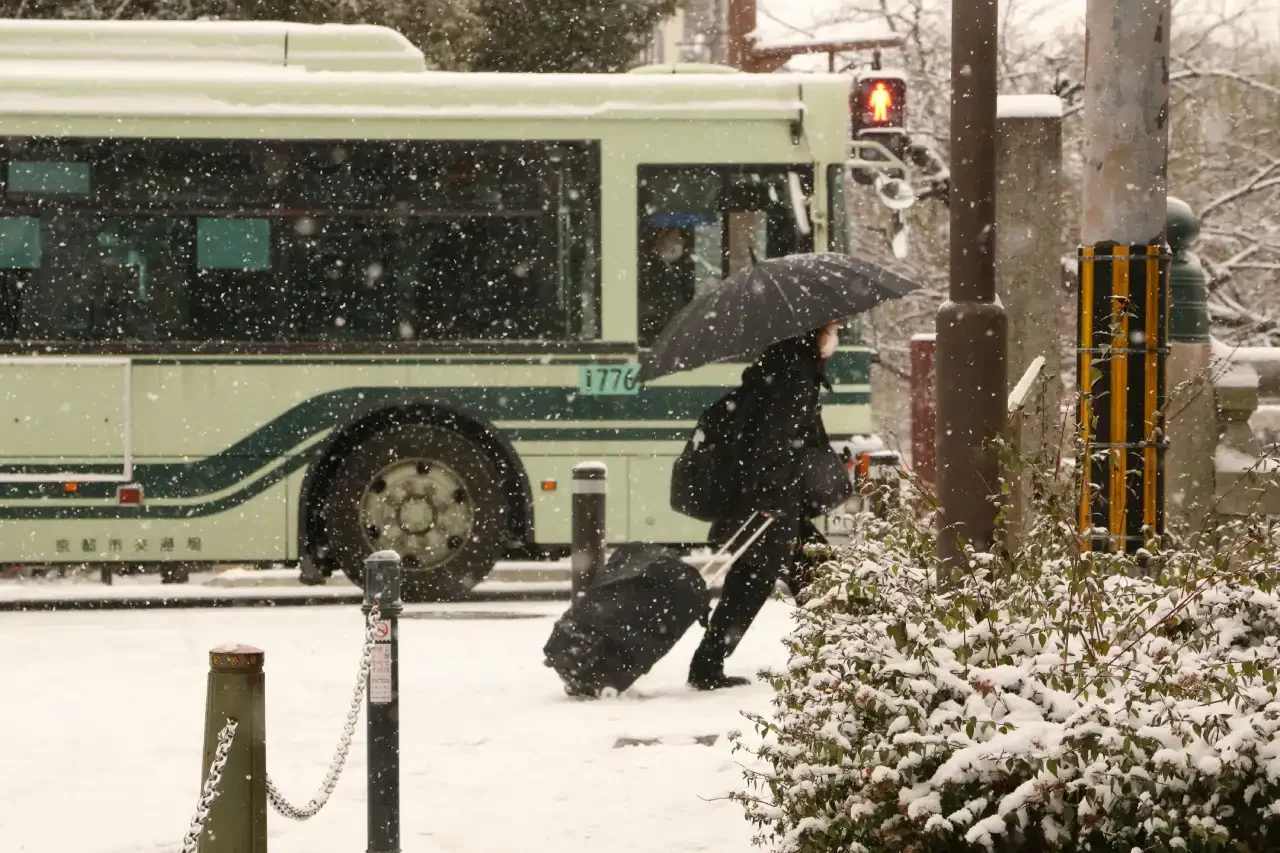 Carrying luggage through Japan while it snows